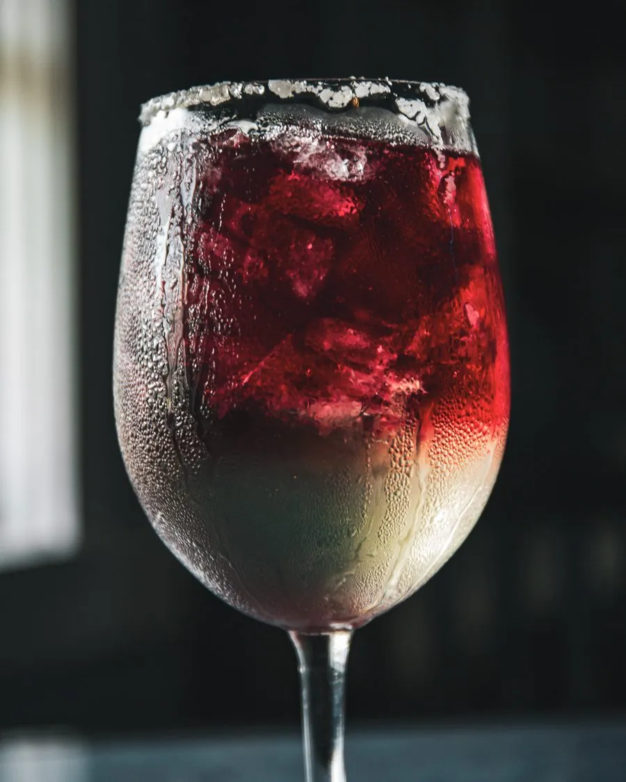 The Devils Margarita, a salted rim glass with red wine floated over a pale margarita
