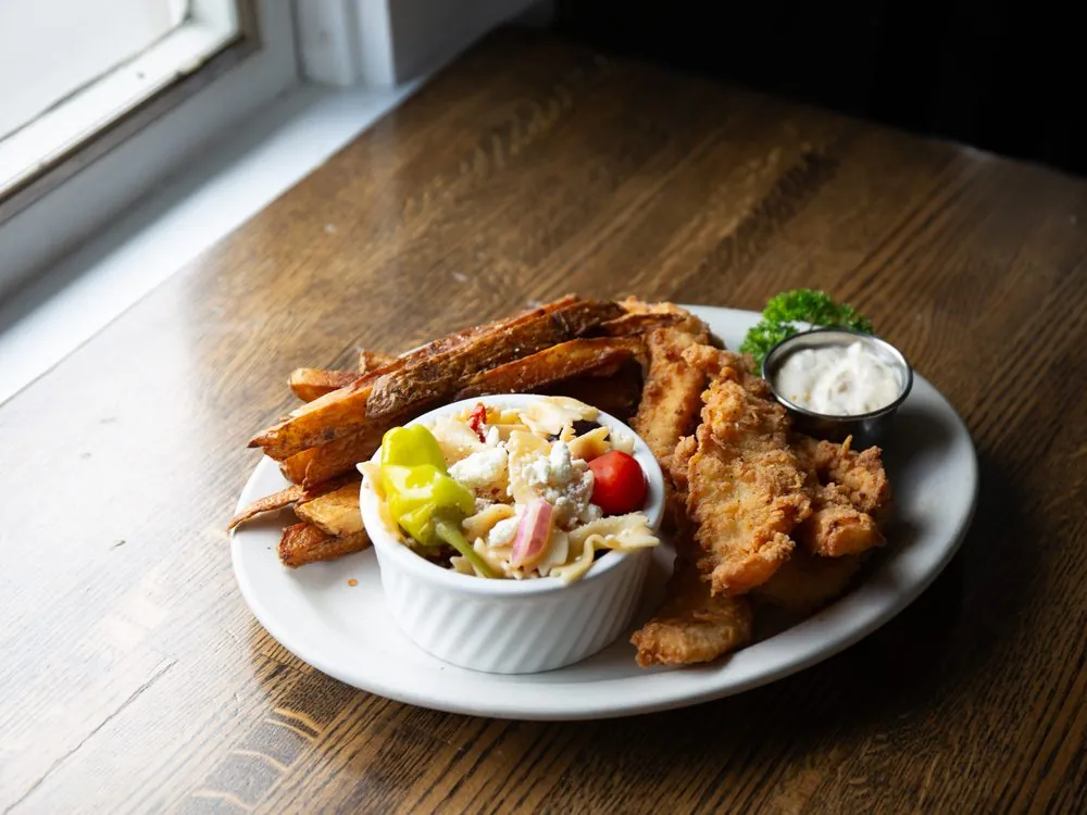 Hand breaded chicken tenders with fresh cut steak fries and slaw