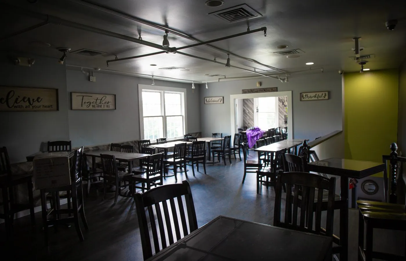 The upstairs dining room set with tables and chairs